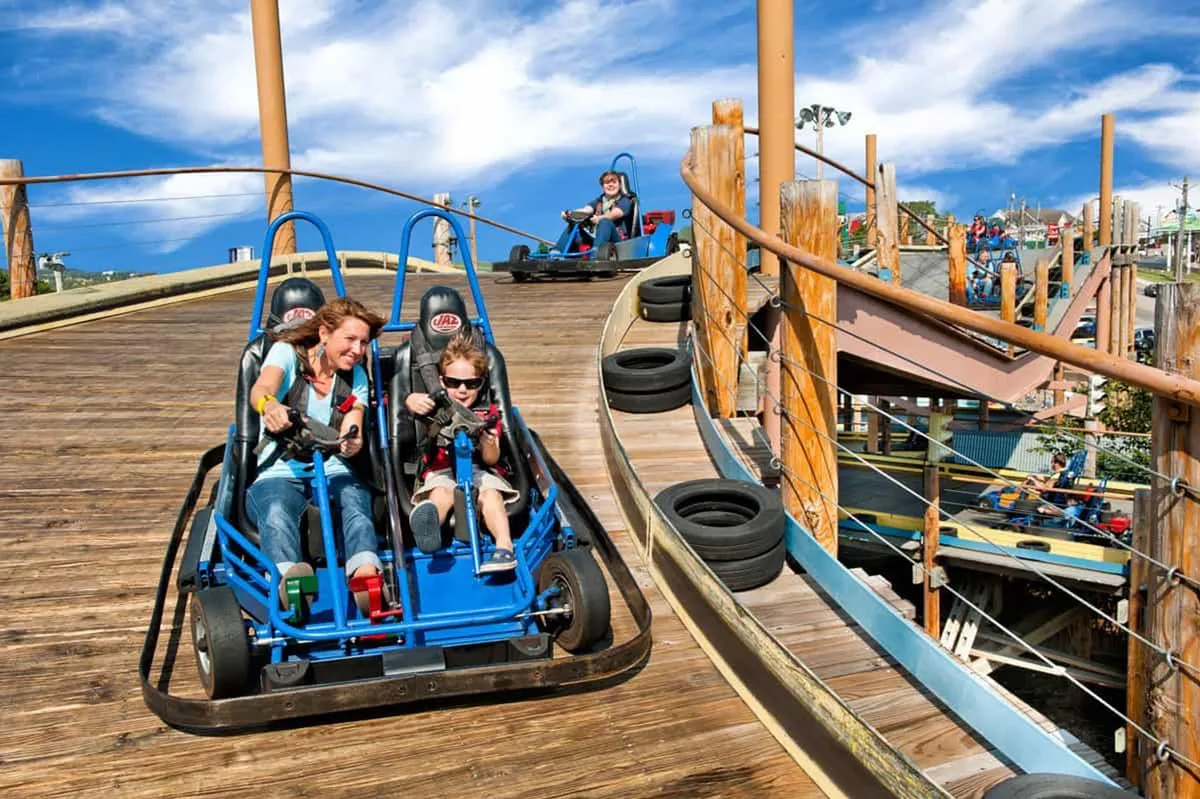This lively exterior image captures kids laughing and racing go-karts on a wooden track, surrounded by colorful scenery. The joyful atmosphere is full of energy, perfect for family outings and bonding moments.